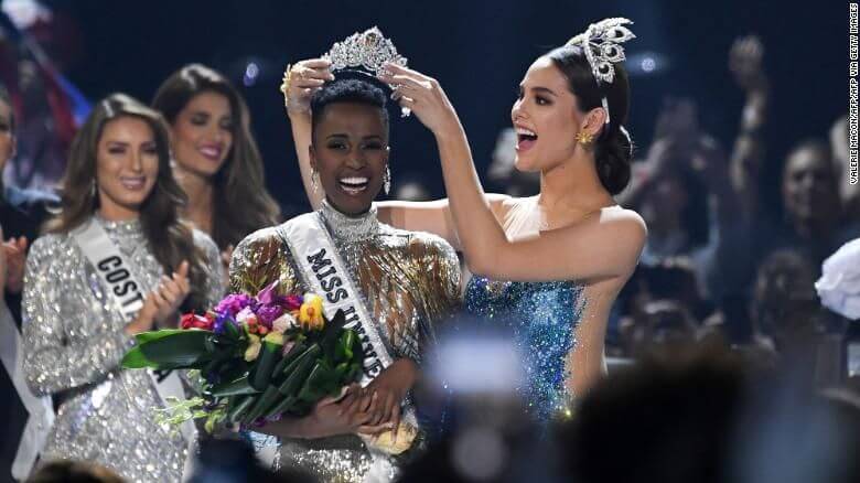 Miss Universe 2018 Philippines' Catriona Gray (R) crowns the new Miss Universe 2019 South Africa's Zozibini Tunzi on stage during the 2019 Miss Universe pageant at the Tyler Perry Studios in Atlanta, Georgia on December 8, 2019. (Photo by VALERIE MACON / AFP) (Photo by VALERIE MACON/AFP via Getty Images)