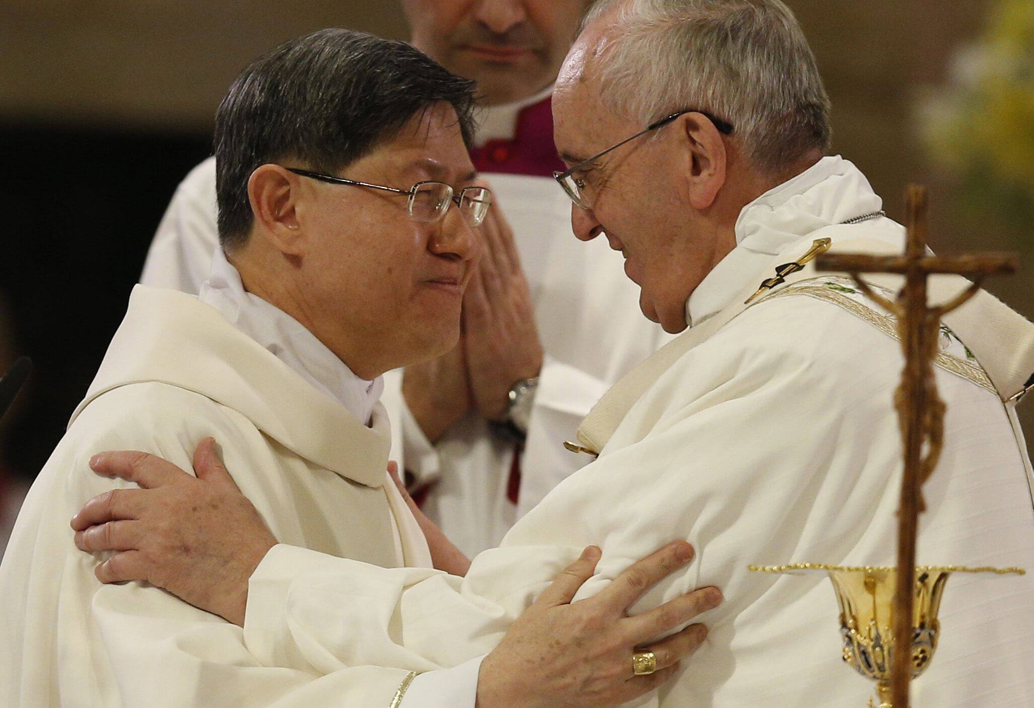 Pope Francis greets Cardinal Luis Antonio Tagle of Manila at the sign of peace at cathedral in Manila, Philippines